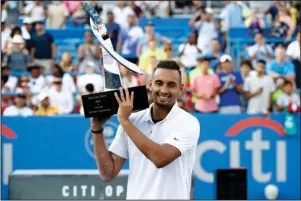  ?? The Associated Press ?? A NEW PATH: Nick Kyrgios, of Australia, poses for photos with a trophy after defeating Daniil Medvedev, of Russia, in Sunday’s final match at the Citi Open tennis tournament in Washington.