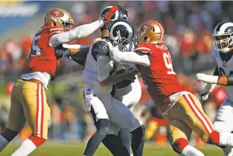  ?? Scott Strazzante / The Chronicle 2019 ?? Dee Ford (left) and Arik Armstead sandwich the Rams’ Jared Goff for a sack in October. The 49ers tied for fifth in the NFL with 48 sacks this season, up from 37 a season earlier.