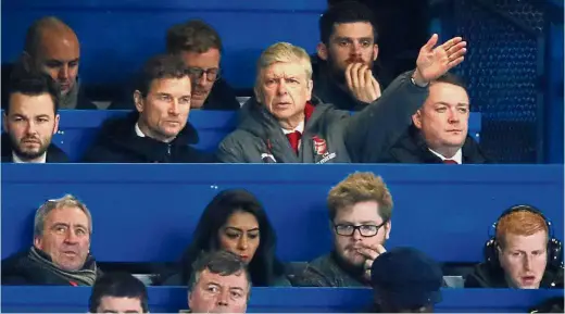  ??  ?? Unfamiliar territory: Arsenal manager Arsene Wenger (second row from top, second right) sitting among journalist­s in the media tribune during the English League Cup match against Chelsea at Stamford Bridge on Wednesday. The match ended 0- 0.