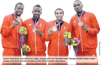  ??  ?? Jarrin Solomon, second from right, poses with his Trinidad and Tobago 4x400 meter teammates and their bronze medals at the 2012 London Olympics.