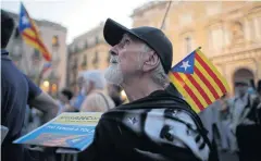  ??  ?? SPLIT DECISION: A man holds an estelada, or pro-independen­ce flag, during a rally in Barcelona, Spain, on Friday.