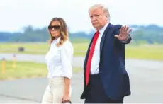  ?? AP PHOTO/MANUEL BALCE CENETA ?? President Donald Trump and first lady Melania Trump walk on the tarmac Friday upon arrival at Morristown Municipal Airport, in Morristown, N.J.