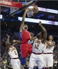  ?? CHRIS SZAGOLA — ASSOCIATED PRESS ?? The 76ers’ Boban Marjanovic dunks with Collin Sexton (2), David Nwaba (12) and Channing Frye (9) defending during the first half March 12 in Philadelph­ia.