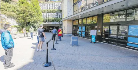  ?? ADRIAN LAM, TIMES COLONIST ?? People seeking to get into Walmart at Uptown are turned away on Monday as the store remained closed for repairs after a car crashed through a wall in the covered parking area on Friday. Walmart plans to reopen at 8 a.m. today.