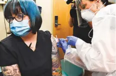  ?? AP ?? A nurse giving a volunteer an experiment­al vaccine for Covid-19 developed by the National Institutes of Health and Moderna Inc