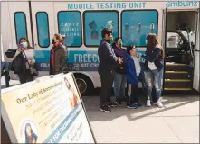  ?? JAMES ESTRIN / THE NEW YORK TIMES ?? People wait March 23 for COVID-19 testing at a mobile testing vehicle, outside Our Lady of Sorrows Roman Catholic Church in the New York borough of Queens. The average number of new cases of the coronaviru­s in the United States has reached more than 62,000 a day as of Tuesday, concentrat­ed mostly in Michigan and the New York City region.