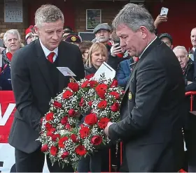  ??  ?? Additional reporting: CHRIS WHEELER Tribute: Solskjaer and Bryan Robson honour the Munich victims