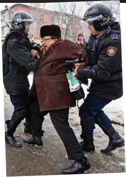  ??  ?? Crackdown: Kazakhstan police grapple with a man protesting about the massacre at Zhanaozen
