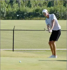  ?? Graham Thomas/Herald-Leader ?? Siloam Springs senior Breck Soderquist chips onto the green during Monday’s golf match at The Course at Sager’s Crossing.