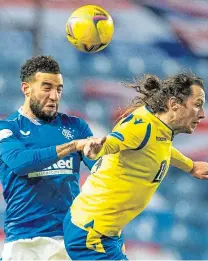  ??  ?? Connor Goldson challenges Stevie May.