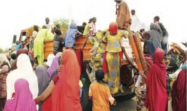  ??  ?? Internally displaced people (IDP), mostly women and children sacked by Boko Haram jihadists, try to climb a truck on a highway to protest against shortage of food and divertion of aid supplies meant for them by camp officials in Maiduguri, northeast Nigeria.
