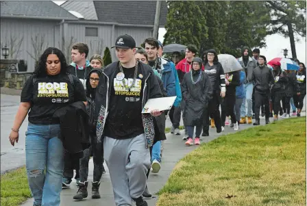  ?? DANA JENSEN/THE DAY ?? Mitchell College juniors Kayla Vargas, front left, and Thomas Simmons, front right, lead the Out of the Darkness walk for suicide prevention Saturday along Pequot Avenue in New London.