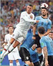  ?? / AP-Francisco Seco ?? Portugal’s Cristiano Ronaldo (left) and Uruguay’s Luis Suarez challenge for the ball during the round of 16 match between Uruguay and Portugal in Sochi, Russia.