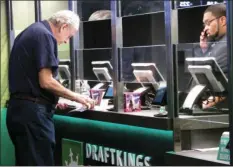  ?? AP PHOTO/WAYNE PARRY ?? In this Oct. 8 2019 file photo, a gambler makes a sports bet at Resorts casino in Atlantic City, N.J. On Sunday, British gambling company Super Group announced a deal to become publicly traded and enter the U.S. sports betting market, including New Jersey.