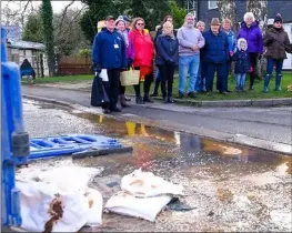  ??  ?? Lambourn residents protest against sewage erupting from the Newbury Street manhole earlier this year