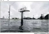  ?? GERALD HERBERT/AP ?? Floods from a weakening Cindy creep up a mailbox Thursday in Big Lake, La. A suspected twister hit Alabama.
