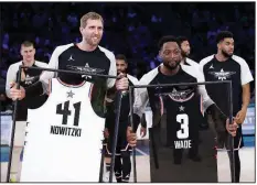  ?? AP/CHUCK BURTON ?? Dirk Nowitzki of the Dallas Mavericks (left) and Dwyane Wade of the Miami Heat are given jerseys during the second half of Sunday’s NBA All-Star Game. Wade has announced he is retiring at the end of the season.