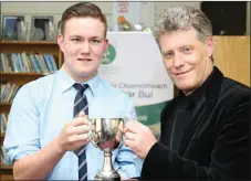  ??  ?? Liam O’ Connor presenting the Corn an Runaí award to Boherbue native Donal Casey.