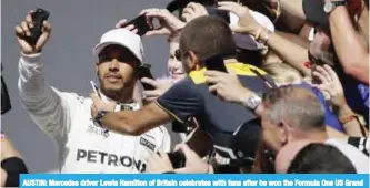  ?? —AP ?? AUSTIN: Mercedes driver Lewis Hamilton of Britain celebrates with fans after he won the Formula One US Grand Prix auto race.