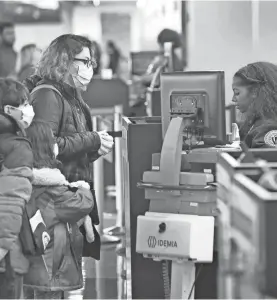  ?? SCOTT OLSON/GETTY IMAGES ?? Passenger go through TSA screening at a nearly-deserted O’Hare Internatio­nal Airport on April 2 in Chicago, Ill.