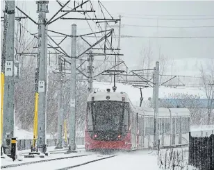  ?? JUSTIN TANG THE CANADIAN PRESS ?? A train on the Confederat­ion Line during a snowstorm in Ottawa on Thursday. Electrical problems during the snowstorm shut down many of the cars on the system.