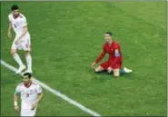  ?? DARKO BANDIC — THE ASSOCIATED PRESS ?? Portugal’s Cristiano Ronaldo, right, reacts after receiving a foul by Iran’s Saeid Ezatolahi, top left, during the group B match between Iran and Portugal at the 2018 soccer World Cup at the Mordovia Arena in Saransk, Russia, Monday.