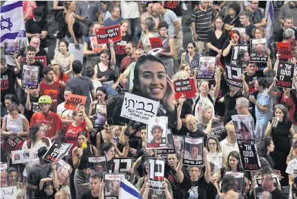  ?? AFP ?? Relatives and supporters of Israelis taken hostage by Palestinia­n militants in Gaza in the Oct 7 attacks, demonstrat­e calling for their release in the central city of Tel Aviv on Saturday.