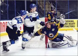  ?? DAVID CROMPTON/The Okanagan Weekend ?? Vernon Vipers goaltender Ty Taylor loses his mask during a scramble in front of the net on Friday at the SOEC. The Vipers and Penticton Vees battled to a 2-2 tie.