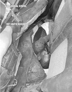  ??  ?? Two African migrants hidden in a false bottom of a car that forced a frontier post between Morocco and the Spanish enclave of Melilla. — AFP photo