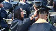  ?? ?? Camille Wallace adjusts T.K. Walker’s graduation cap.