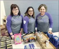  ?? SUBMITTED PHOTOS ?? Mariela Landa, from left, Sandy Aguirre and Maybelline Hensley, employees of Community Action Program for Central Arkansas, give out free items during the second Project Homeless Connect, which the agency in Conway organized. The one-stop event brought...