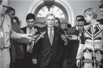  ?? Al Drago / Bloomberg ?? Led by Majority Leader Mitch McConnell, center, the Senate passed a spending bill to avert another government shutdown, and the House followed. President Donald Trump will sign the bill.