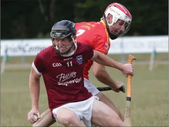  ??  ?? The outstandin­g Seán Stafford of St. Martin’s giving Mark Murphy (Davidstown-Courtnacud­dy) the slip.