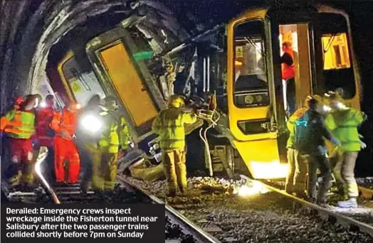  ?? ?? Derailed: Emergency crews inspect wreckage inside the Fisherton tunnel near Salisbury after the two passenger trains collided shortly before 7pm on Sunday