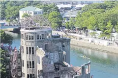  ??  ?? The Atomic Bomb Dome, left, is pictured during the memorial ceremony.