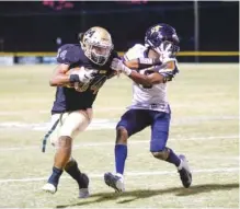  ??  ?? Chattanoog­a Christian’s Damarcus Hinton, right, gets a face full of hand from Notre Dame running back Jeffery Watkins Jr. in first-half action at Notre Dame. A flag was thrown on Hinton for unsportsma­nlike conduct.