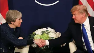  ?? (Reuters) ?? US PRESIDENT Donald Trump greets Prime Minister Theresa May during the World Economic Forum in Davos earlier this year.