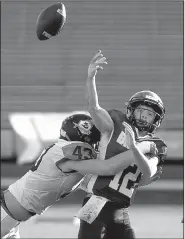  ?? Arkansas Democrat-Gazette/THOMAS METTHE ?? Little Rock Christian linebacker Grant McElmurry (43) hits Pulaski Academy quarterbac­k Braden Bratcher (12) as he throws during the second quarter Sunday. The Warriors forced five turnovers, including three in the second half, as they ended Pulaski Academy’s drive for five consecutiv­e state championsh­ips.