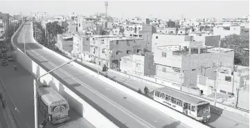  ??  ?? Photo shows a general view of the elevated corridor of the Green Line Bus Rapid Transit System along a low income neighbourh­ood in Karachi, Pakistan. — Reuters photo