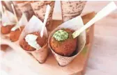  ??  ?? Eggplant arancini with burrata, mint aioli and garlic chives from Fellow Osteria at the 2019 Devour Culinary Classic at the Desert Botanical Garden in Phoenix.