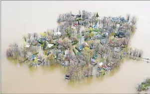  ?? CP PHOTO ?? Ile Mercier covered in floodwater is seen on the Riviere des Prairies on the north part of Montreal Monday. The bridge leading to the island is closed with its residents evacuated.