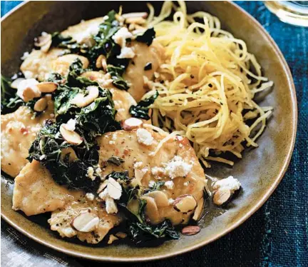  ?? ANGIE NORWOOD BROWNE/THE SEATTLE TIMES ?? Chicken with garlic, greens and salty cheese is a favorite in Susan Volland’s “Searing Inspiratio­n.”