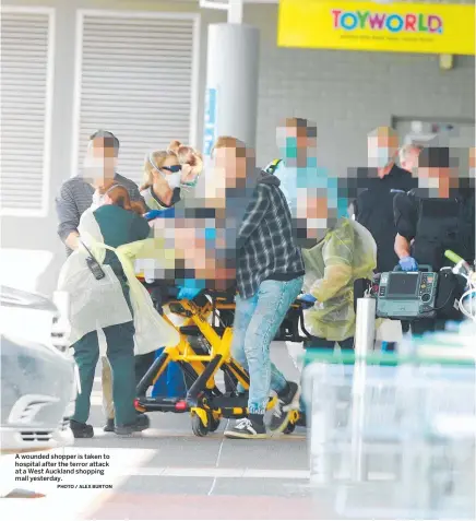  ?? PHOTO / ALEX BURTON ?? A wounded shopper is taken to hospital after the terror attack at a West Auckland shopping mall yesterday.