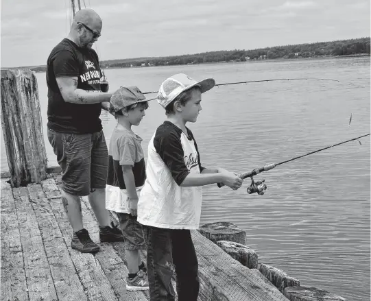  ?? KATHY JOHNSON • SALTWIRE NETWORK ?? From left, Lewis Gilbert, Jack Hendrixson and Alister Hendrixson enjoy an afternoon fishing for mackerel on the Lahave River.