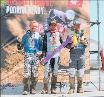  ??  ?? Below: Woodville NZ MX1 Grand Prix placegette­rs — From left: Kirk Gibbs (2nd), Hamish Harwood (1st), Ethan Martins (3rd).