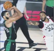  ?? ASHLEY LANDIS - THE ASSOCIATED PRESS ?? Boston Celtics’ Jayson Tatum shoots as Toronto Raptors’ Norman Powell (24) defends during the second half of an NBA basketball conference semifinal playoff game Sunday, Aug. 30, 2020, in Lake Buena Vista, Fla.