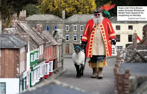  ?? ANDREW MATTHEWS ?? Town crier Chris Brown walks through Wimborne Model Town ahead of its reopening on Monday
