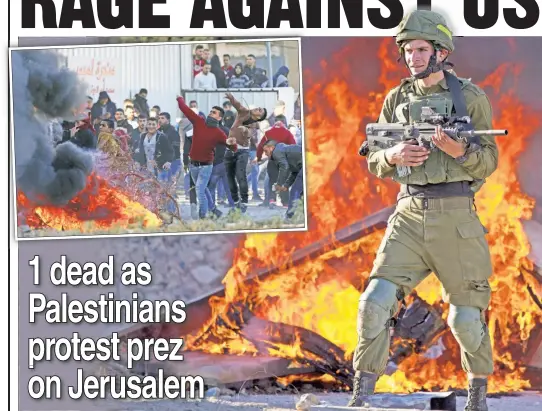  ??  ?? FIERY ANGER: An Israeli soldier is on high alert Friday amid Palestinia­n fury over President Trump’s decision to relocate the US Embassy to Jerusalem.