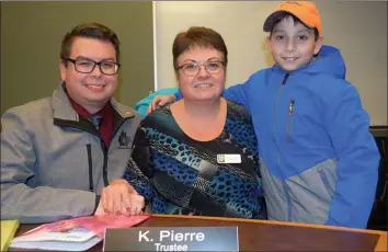  ?? JAMES MILLER/Penticton Herald ?? Newly-elected Okanagan Skaha School Board trustee Kathy Pierre is hugged by her son Joseph and grandson Taylor, age 10, following the board’s inaugural meeting, Monday.