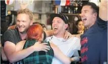  ?? PIERRE OBENDRAUF ?? James Roberts, far left, Ollie Kavanagh, centre, with his wife, Kat, and friend Jeremy O’Brien, far right, celebrate England’s victory over Colombia earlier this week at pub in Mile End.